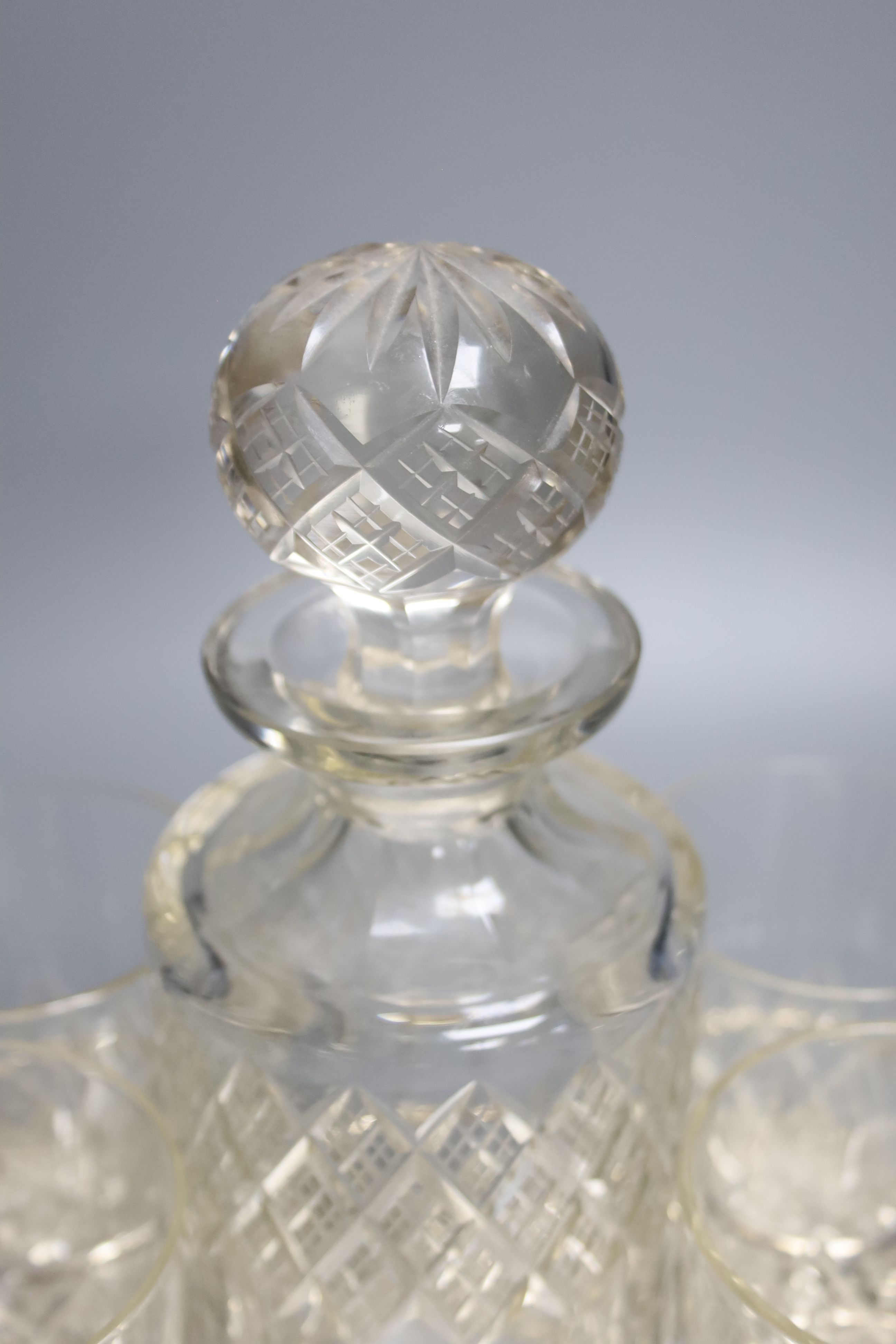 A decanter and four glasses, on plated stand, width 24cm